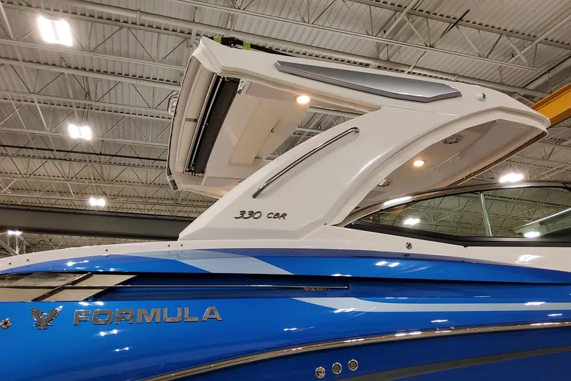 Slide: The Image of 2027 Formula 330 Crossover Bowrider OB, sleek blue design, showcased indoors. - 7