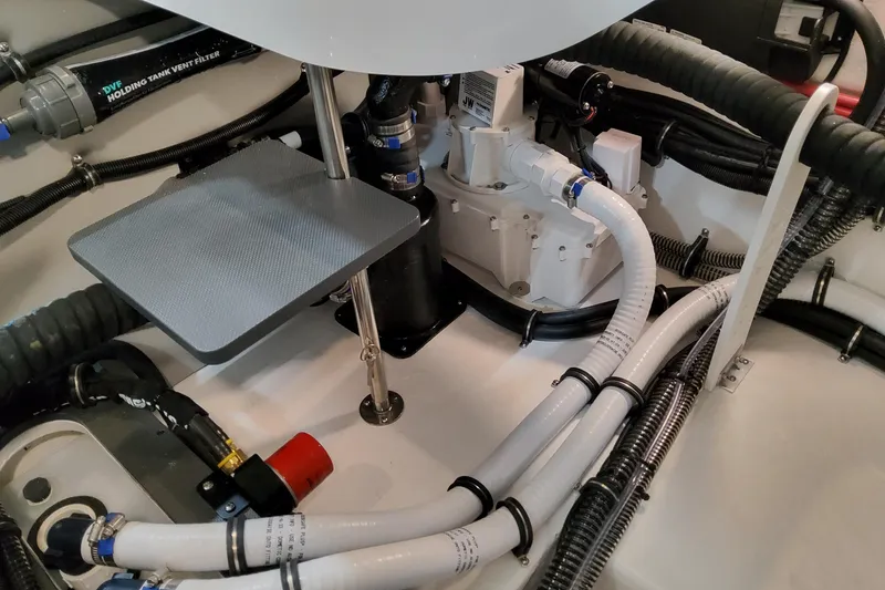 Slide: The Image of Engine compartment of 2027 Formula 330 Crossover Bowrider OB with hoses and components. - 73