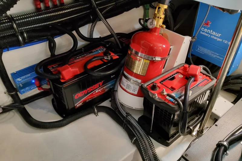Slide: The Image of Battery and fire extinguisher setup in 2027 Formula 330 Crossover Bowrider OB boat. - 77