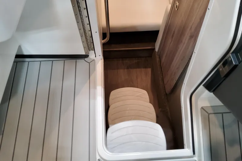 Slide: The Image of Interior view of 2027 Formula 330 Crossover Bowrider OB, featuring sleek seating and wood accents. - 78