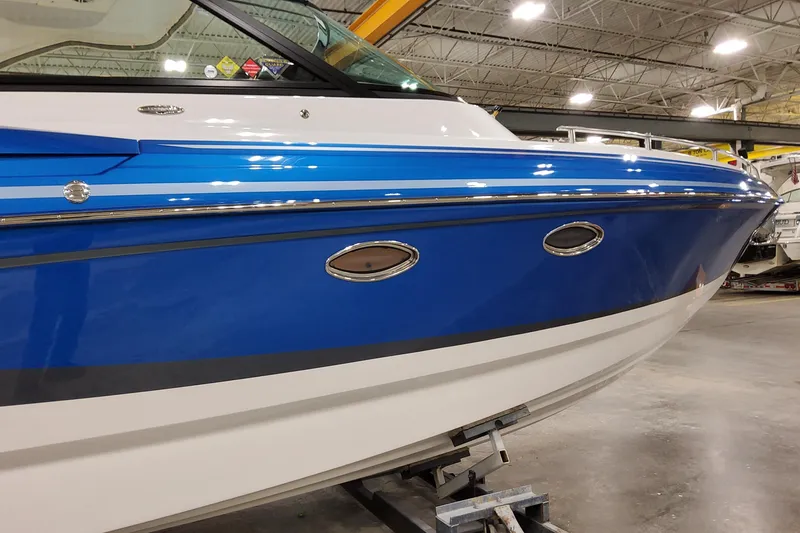 Slide: The Image of 2027 Formula 330 Crossover Bowrider OB in a showroom, featuring sleek blue and white design. - 8