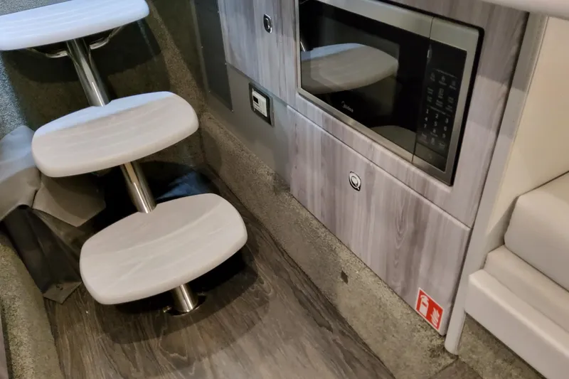 Slide: The Image of Interior of 2027 Formula 330 Crossover Bowrider OB with steps and built-in microwave. - 82