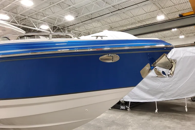 Slide: The Image of 2027 Formula 330 Crossover Bowrider OB in a showroom, showcasing sleek blue hull design. - 9