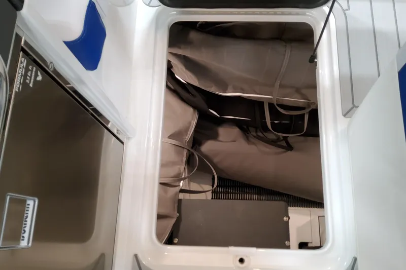 Slide: The Image of Storage compartment in 2027 Formula 330 Crossover Bowrider OB boat, featuring organized interior space. - 90