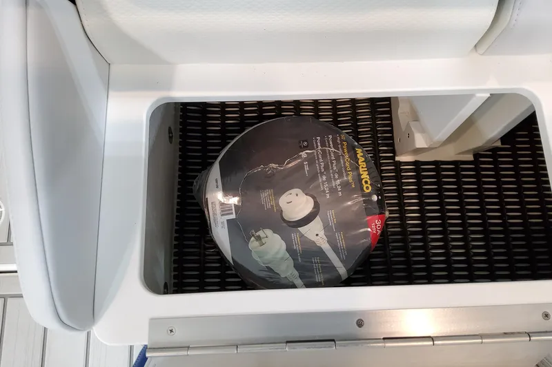 Slide: The Image of Storage compartment in 2027 Formula 330 Crossover Bowrider OB with power cord reel. - 94