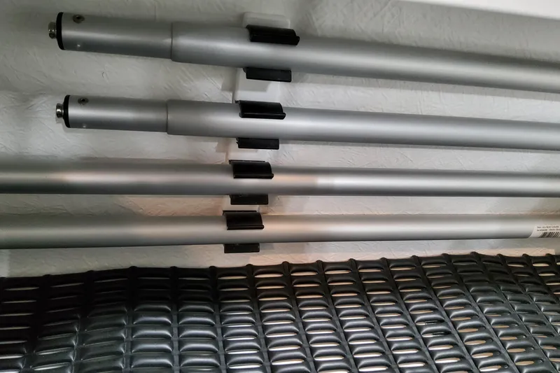 Slide: The Image of Silver poles and black mesh in a 2027 Formula 330 Crossover Bowrider OB. - 96