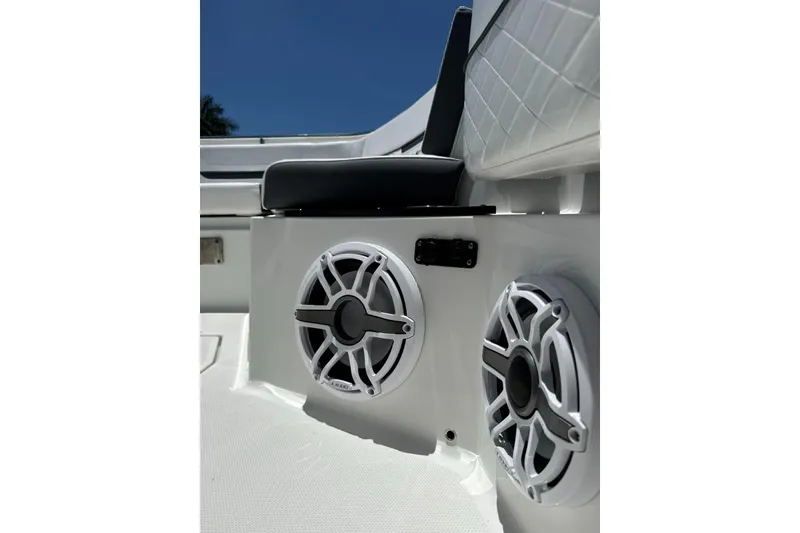 Slide: The Image of 2022 Blackfin 252 CC boat interior with speakers and cushioned seating. - 19
