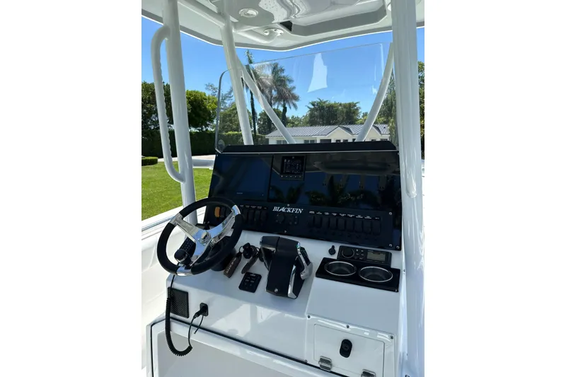 Slide: The Image of 2022 Blackfin 252 CC boat console with steering wheel and controls. - 21