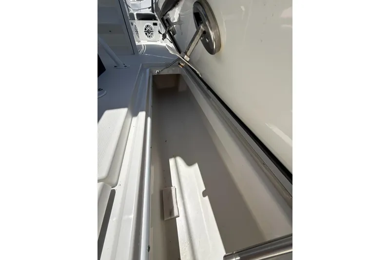 Slide: The Image of Open storage compartment on a 2022 Blackfin 252 CC boat, showcasing interior space. - 23