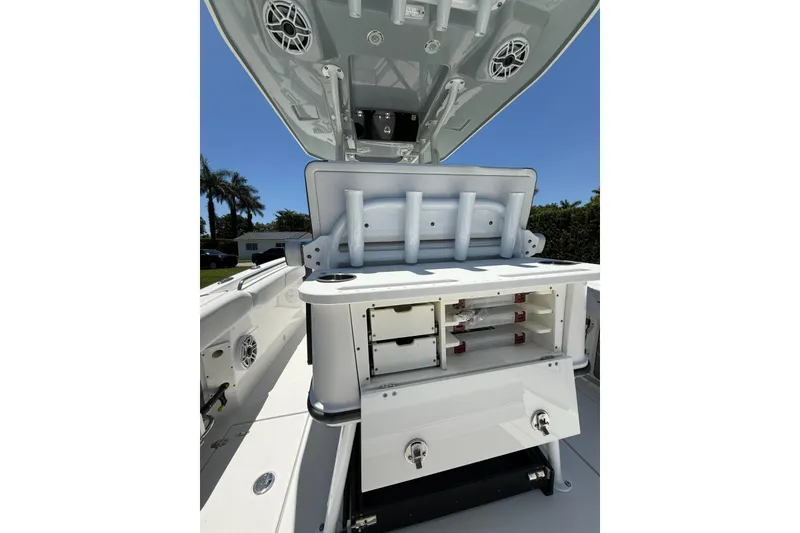 Slide: The Image of 2022 Blackfin 252 CC boat interior with storage compartments and rod holders. - 26