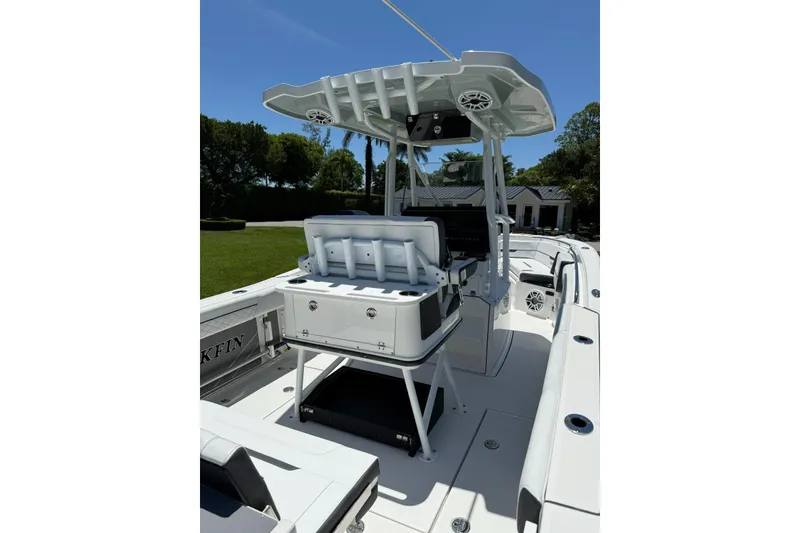 Slide: The Image of 2022 Blackfin 252 CC boat interior with seating and console under a clear blue sky. - 29