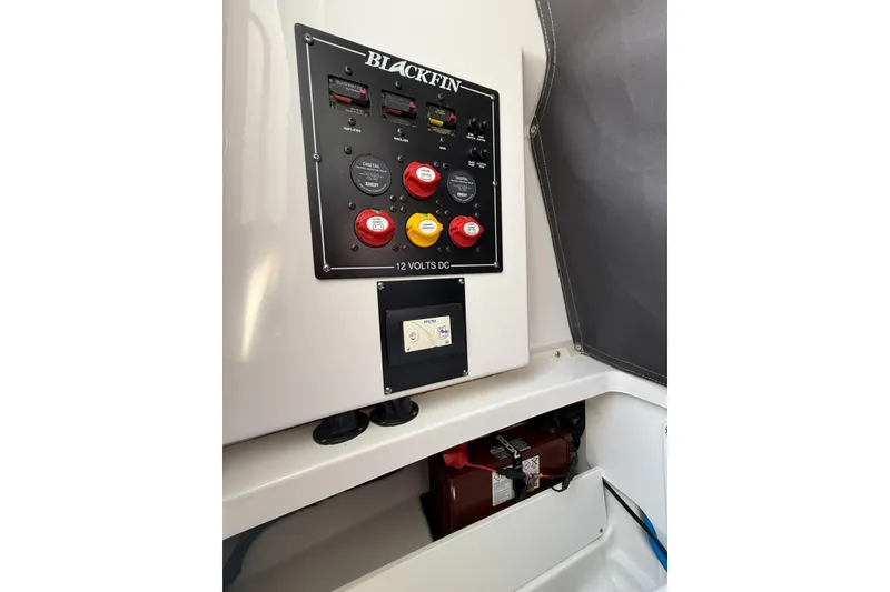 Slide: The Image of Control panel of 2022 Blackfin 252 CC boat, featuring switches and battery compartment. - 33