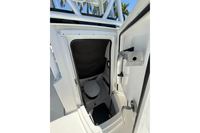 Slide: The Image of 2022 Blackfin 252 CC boat interior with compact marine toilet. - 34