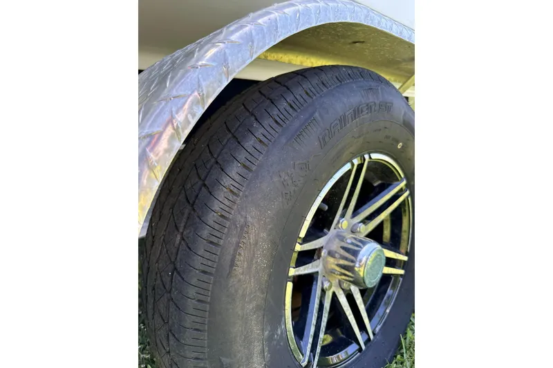 Slide: The Image of Close-up of a 2022 Blackfin 252 CC trailer tire and wheel. - 35