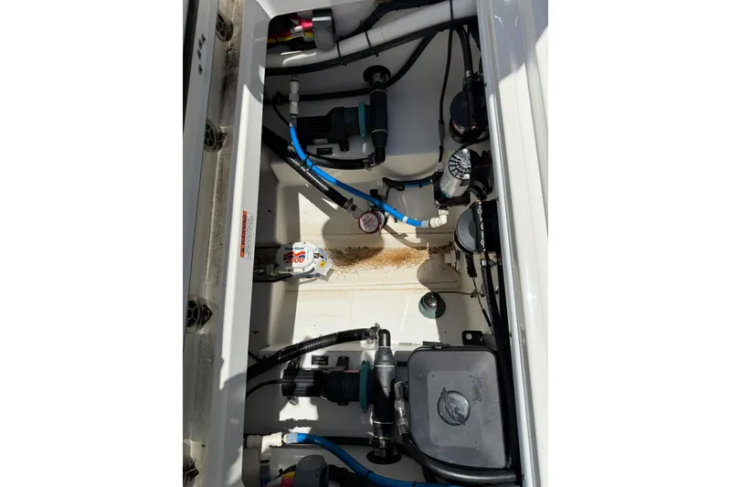 Slide: The Image of Engine compartment of a 2022 Blackfin 252 CC boat, showcasing wiring and components. - 9