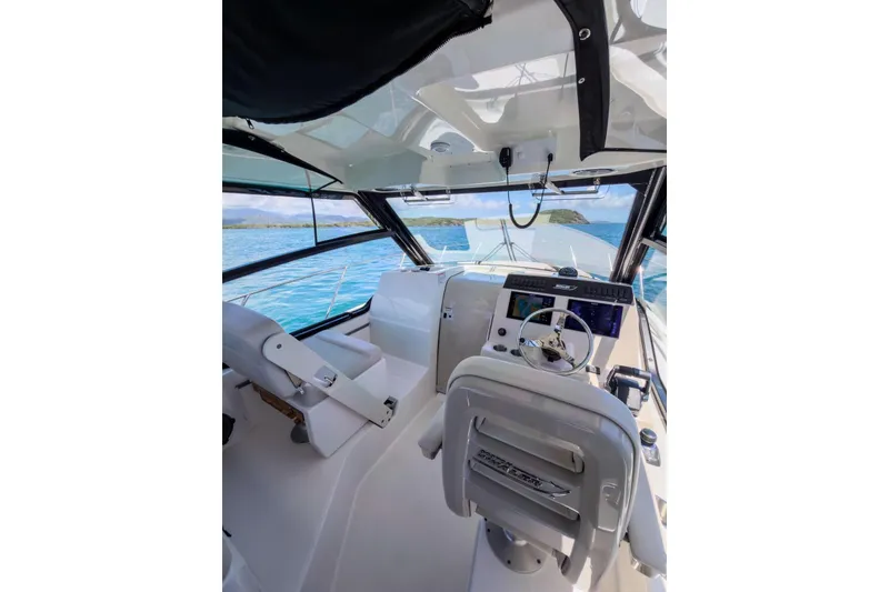 Slide: The Image of 2024 Boston Whaler 325 Conquest cockpit with modern controls and ocean view. - 11