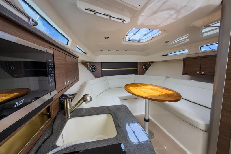 Slide: The Image of Luxurious interior of 2024 Boston Whaler 325 Conquest with modern kitchen and seating area. - 13