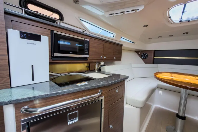 Slide: The Image of Luxurious interior of 2024 Boston Whaler 325 Conquest with modern kitchen and seating area. - 14