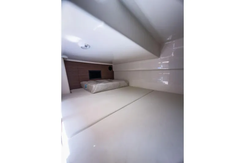 Slide: The Image of Interior cabin of 2024 Boston Whaler 325 Conquest, featuring a cozy sleeping area. - 15