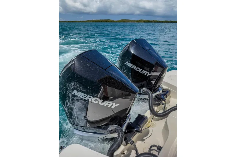 Slide: The Image of Twin Mercury outboard engines on a 2024 Boston Whaler 325 Conquest in open water. - 16