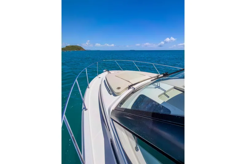 Slide: The Image of 2024 Boston Whaler 325 Conquest cruising on clear blue ocean waters. - 4