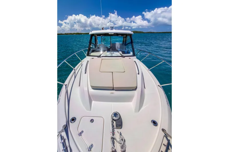 Slide: The Image of 2024 Boston Whaler 325 Conquest boat on clear blue water under a sunny sky. - 5