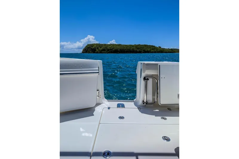 Slide: The Image of Boston Whaler 325 Conquest 2024 boat deck with ocean and island view. - 8