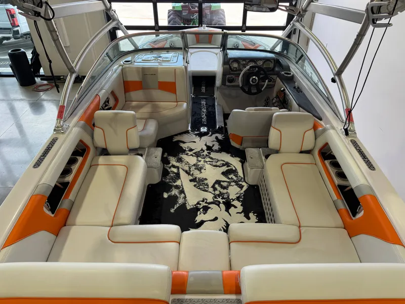 Slide: The Image of Interior of a 2008 Nautique Super Air Nautique 230 boat with orange accents. - 13
