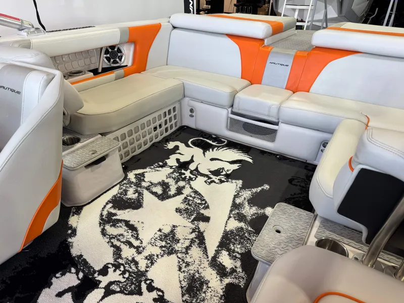 Slide: The Image of Interior of a 2008 Nautique Super Air Nautique 230 boat with orange accents. - 15