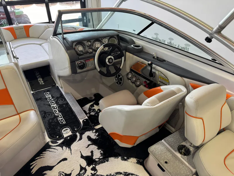 Slide: The Image of Interior of a 2008 Nautique Super Air Nautique 230 boat with orange accents. - 24