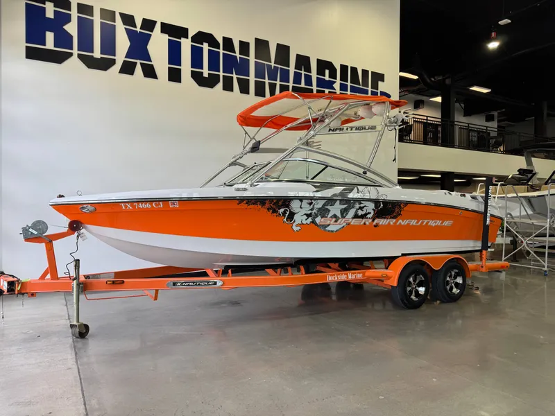 Slide: The Image of 2008 Nautique Super Air Nautique 230 boat in vibrant orange on trailer. - 3