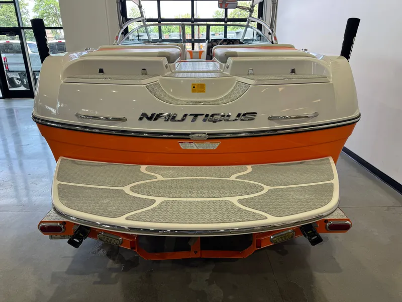 Slide: The Image of Rear view of a 2008 Nautique Super Air Nautique 230 boat in a showroom. - 8