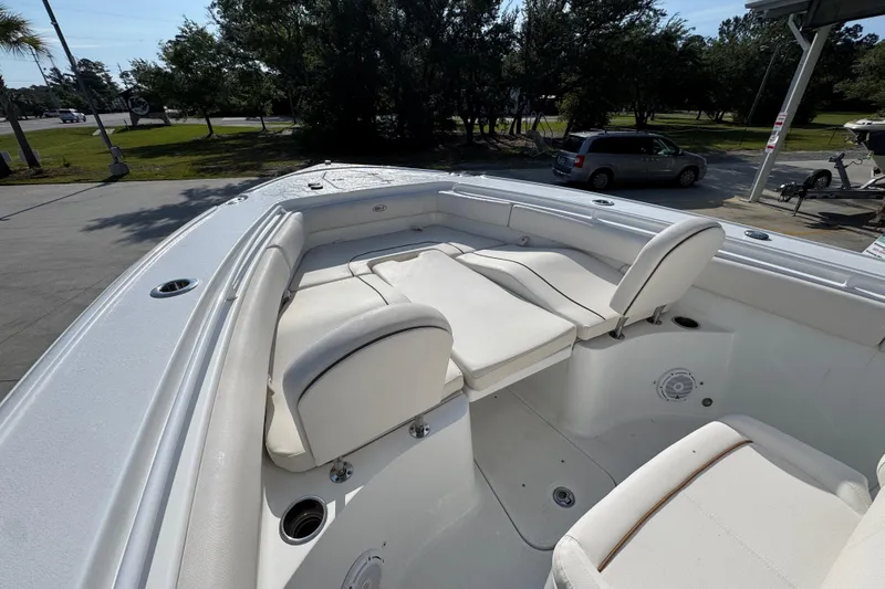 Slide: The Image of 2022 Sea Hunt Ultra 275 SE boat with spacious white seating and sleek design. - 17