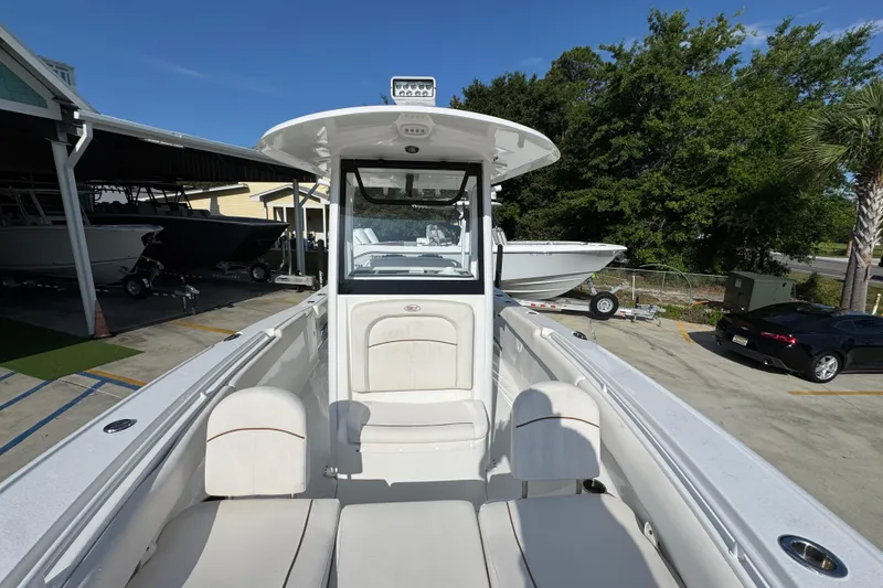 Slide: The Image of 2022 Sea Hunt Ultra 275 SE boat with spacious seating, docked outdoors. - 19