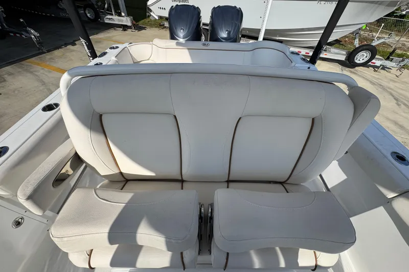 Slide: The Image of 2022 Sea Hunt Ultra 275 SE boat seating with dual engines in the background. - 23