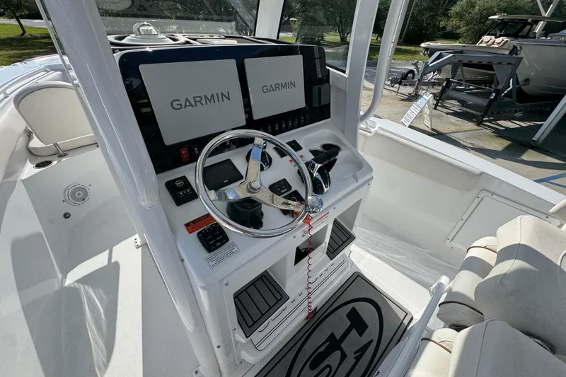 Slide: The Image of 2022 Sea Hunt Ultra 275 SE boat dashboard with Garmin navigation displays. - 25