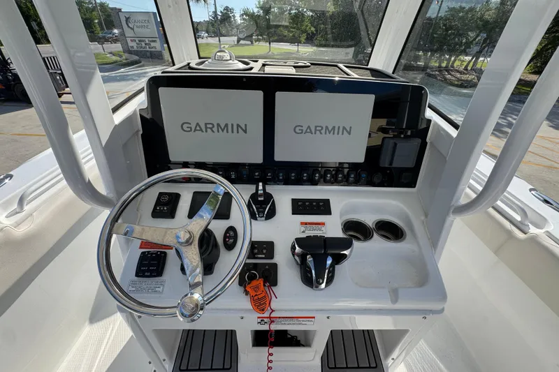 Slide: The Image of 2022 Sea Hunt Ultra 275 SE boat dashboard with Garmin navigation displays. - 26