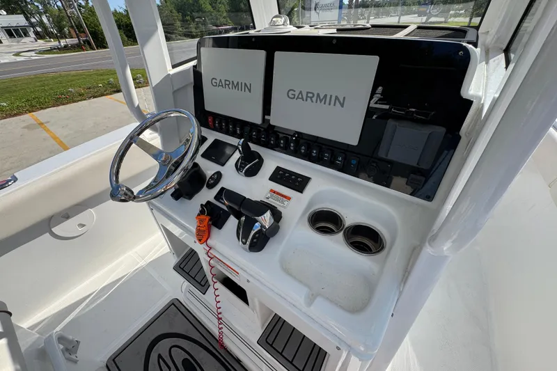Slide: The Image of Helm of 2022 Sea Hunt Ultra 275 SE with Garmin displays and controls. - 27