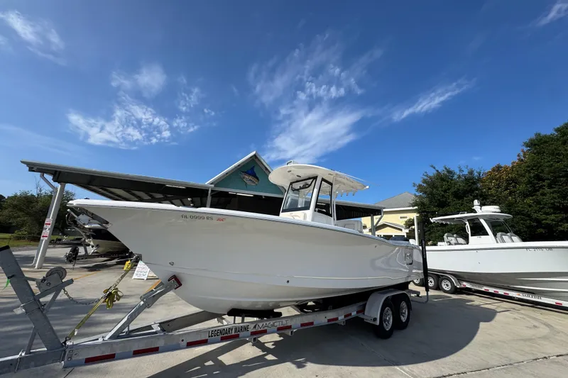 Slide: The Image of 2022 Sea Hunt Ultra 275 SE boat on trailer under clear blue sky. - 3