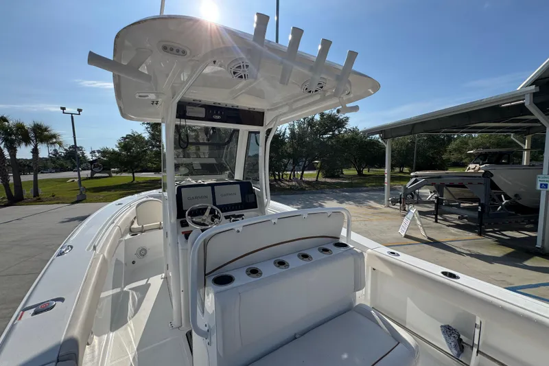 Slide: The Image of 2022 Sea Hunt Ultra 275 SE boat interior with Garmin navigation, docked under clear sky. - 30