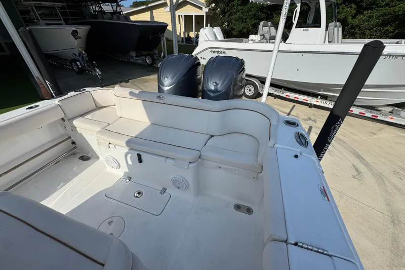 Slide: The Image of 2022 Sea Hunt Ultra 275 SE boat interior with seating and dual engines. - 31