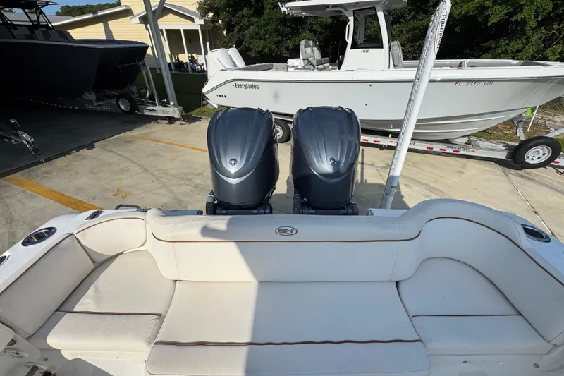 Slide: The Image of 2022 Sea Hunt Ultra 275 SE boat with dual engines, parked on a trailer. - 32