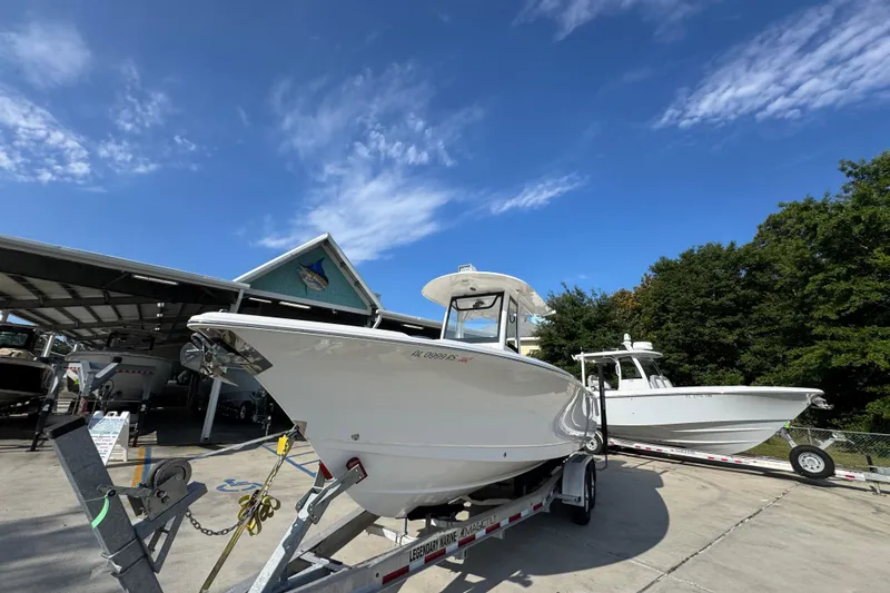 Slide: The Image of 2022 Sea Hunt Ultra 275 SE boat on trailer under clear blue sky. - 4