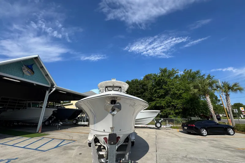 Slide: The Image of 2022 Sea Hunt Ultra 275 SE boat on trailer under clear blue sky. - 5