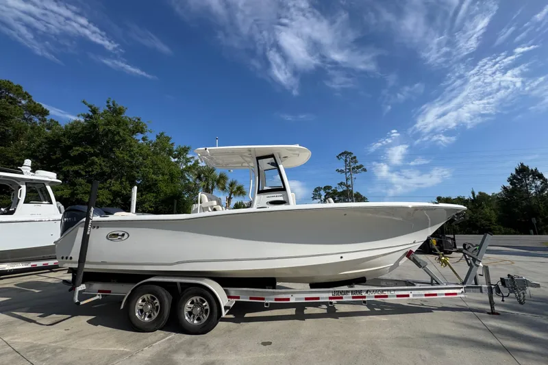 Slide: The Image of 2022 Sea Hunt Ultra 275 SE boat on trailer under clear blue sky. - 8