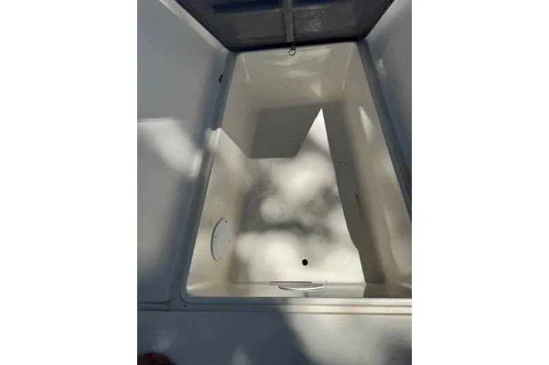 Slide: The Image of Interior view of a 1987 Mako 232 Center Console boat compartment. - 10