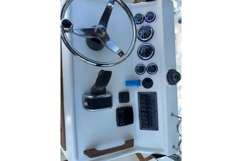 Slide: The Image of 1987 Mako 232 Center Console dashboard with steering wheel and gauges. - 14