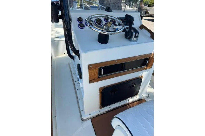 Slide: The Image of 1987 Mako 232 Center Console boat dashboard with steering wheel and controls. - 17