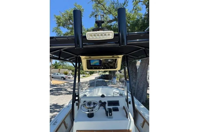 Slide: The Image of 1987 Mako 232 Center Console boat interior with steering wheel and navigation equipment. - 22