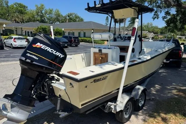 Slide: The Image of 1987 Mako 232 Center Console boat with Mercury Optimax engine on trailer. - 4